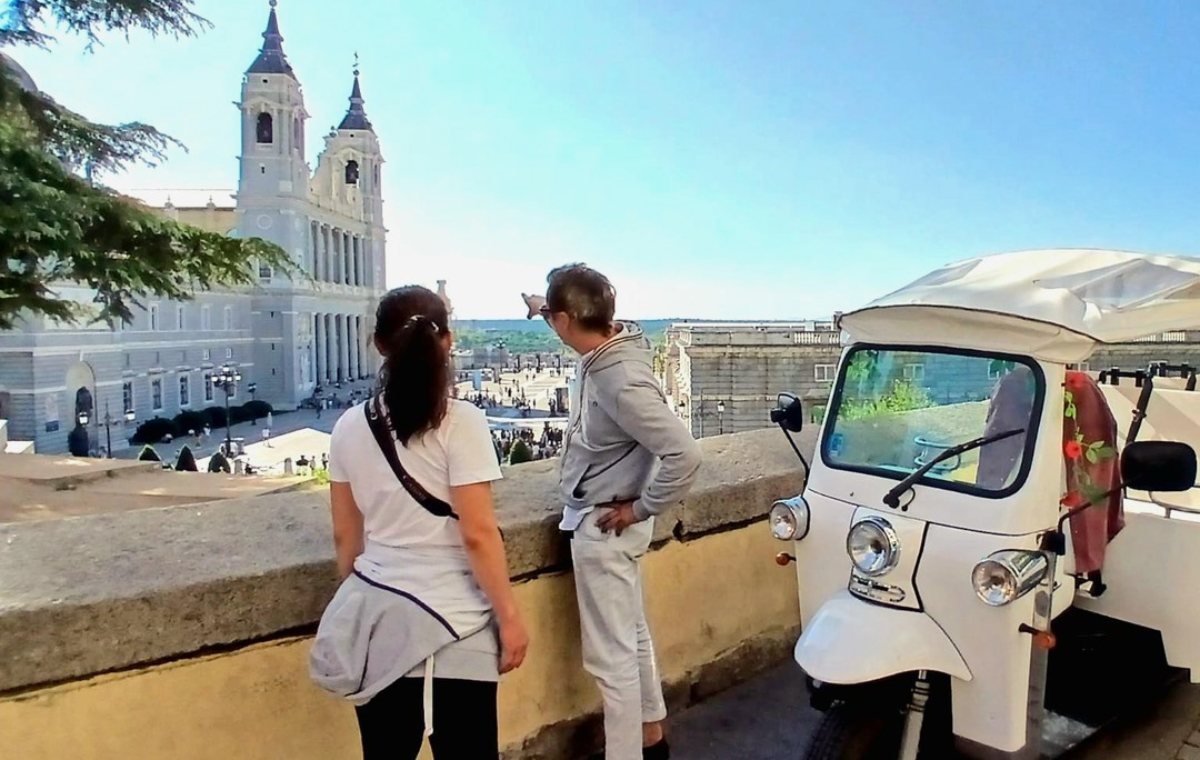 Passengers riding through central Madrid on a Tuk Tuk Tour Madrid sightseeing tour