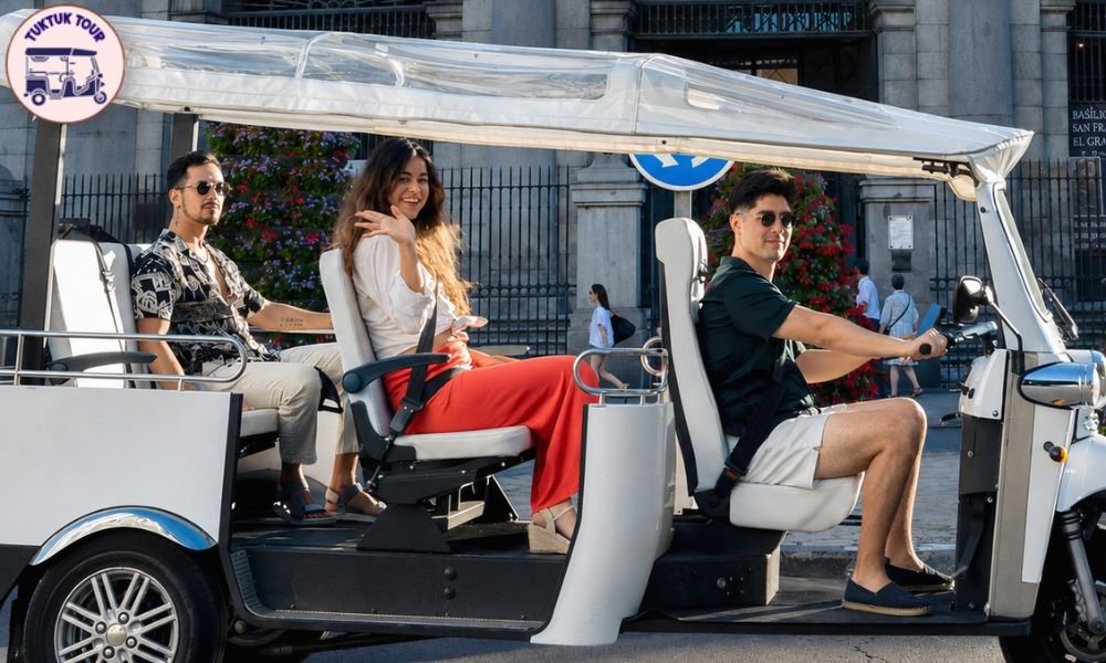 Electric tuk tuk with driver-guide waiting for passengers on a central Madrid street